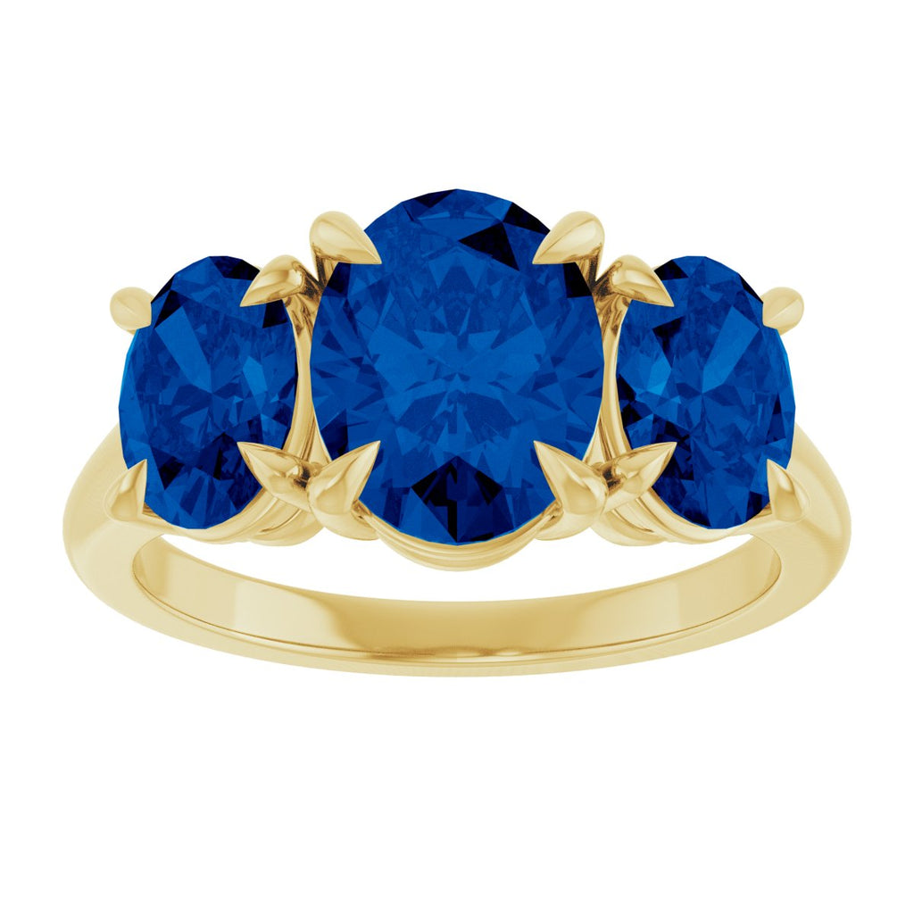 9x7 mm Oval Lab-Grown Blue Sapphire Three-Stone Ring in 14k yellow gold